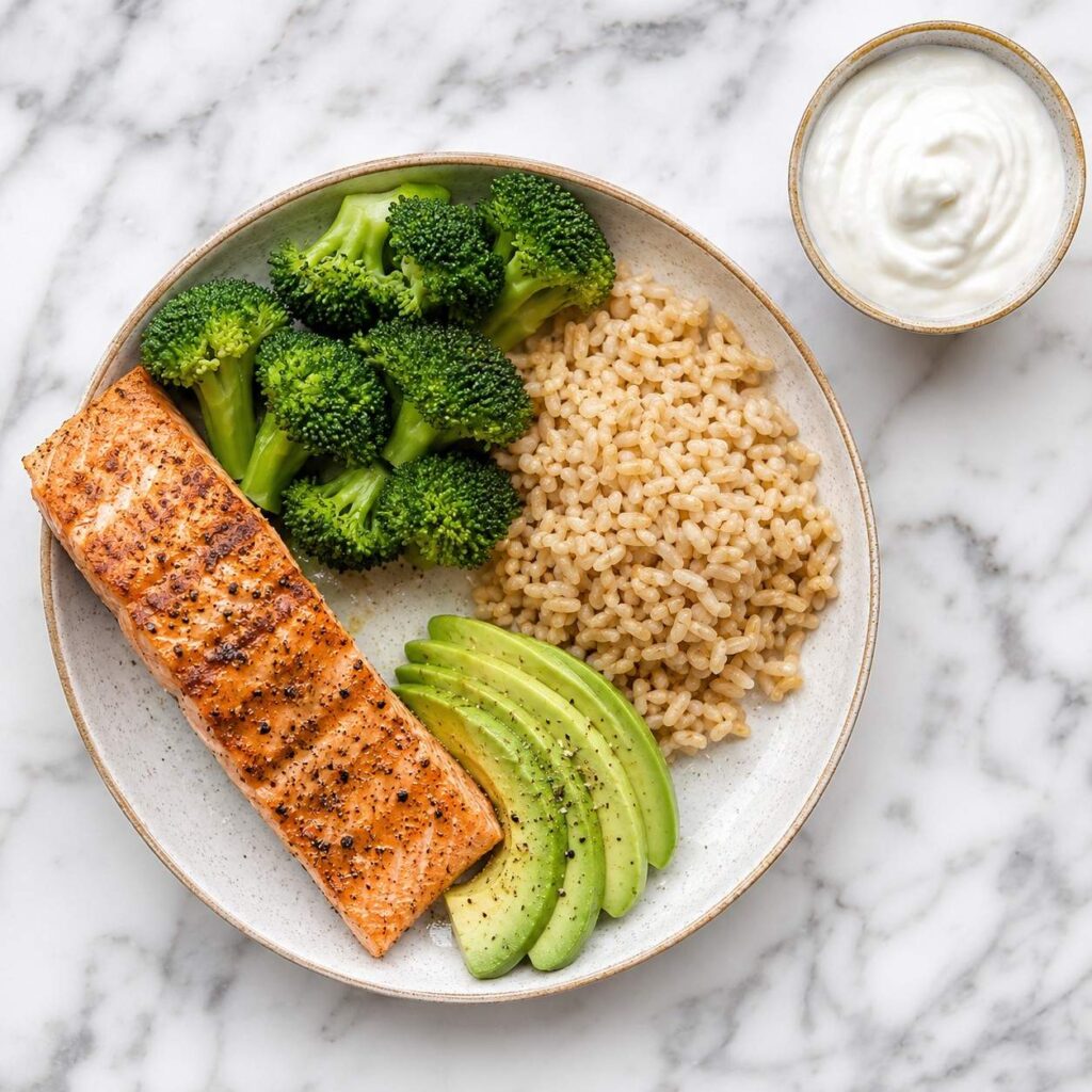 “High-protein meal with salmon, broccoli, rice, avocado, and yogurt”