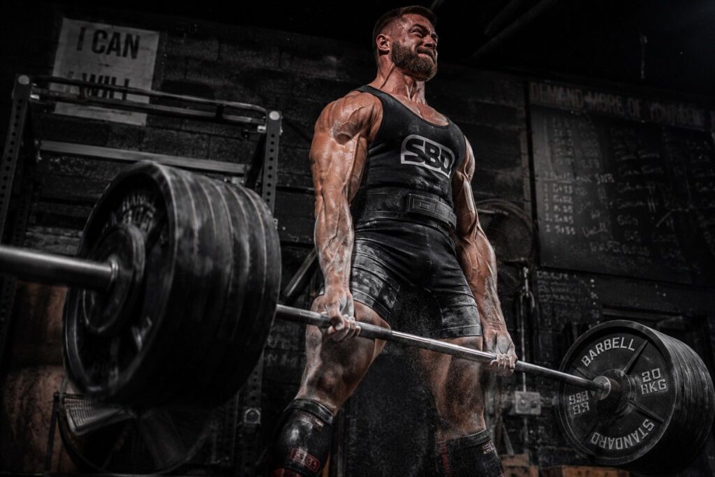Powerlifter performing heavy deadlift showing strength and power output benefits of creatine in pre workout supplement.
