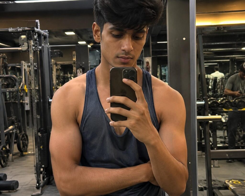 Month 2 mass gainer progress showing early visible muscle fullness in arms and chest during the pump retention phase of body transformation.