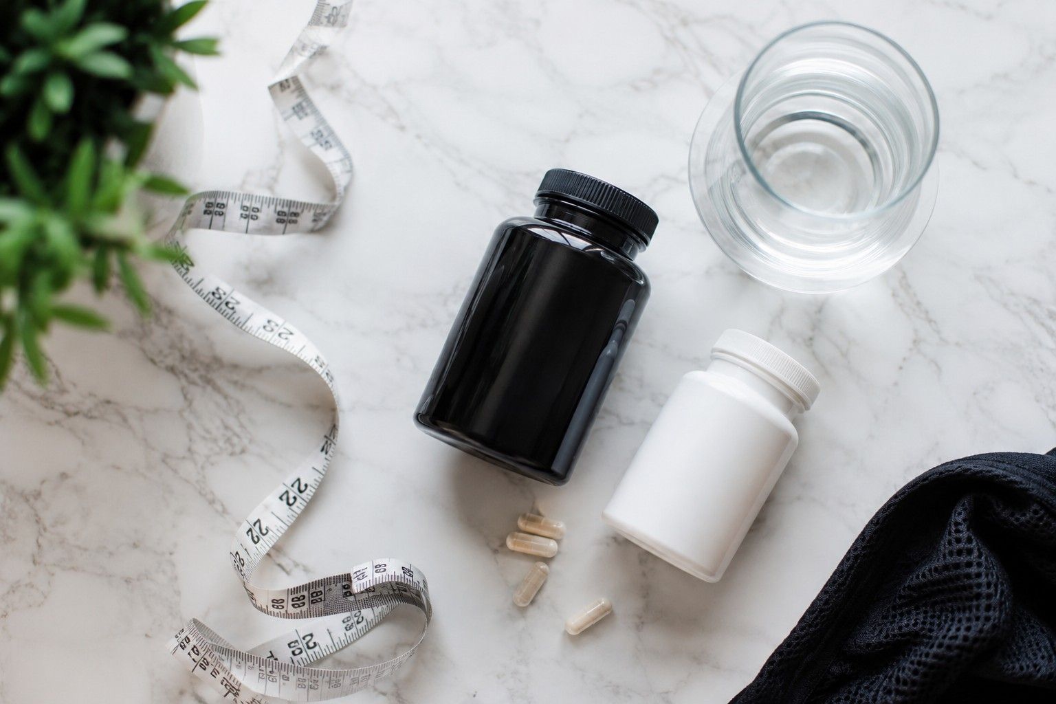 best fat burner for beginners - supplement bottles flat lay